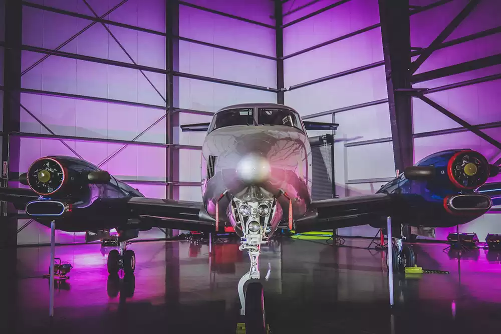 A private jet with quality metal finishing parked inside a hangar