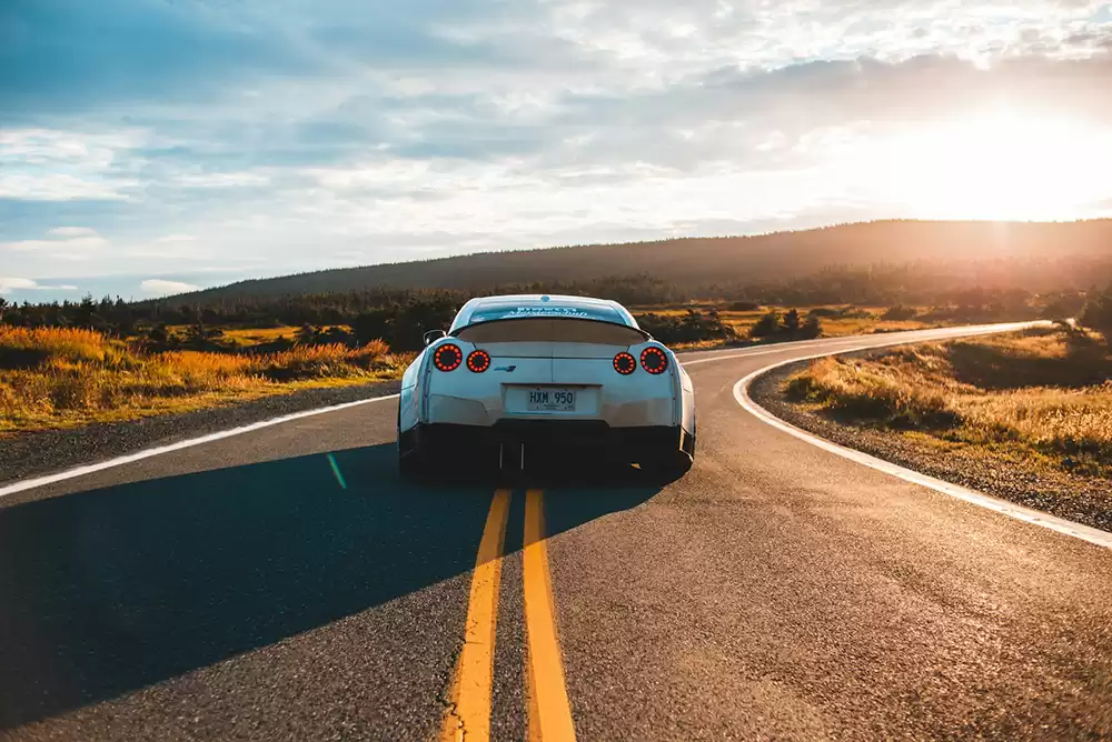 A car driving down a desert road