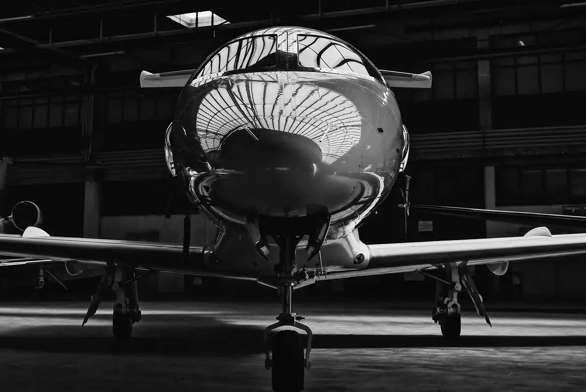 grayscale photo of a small private jet