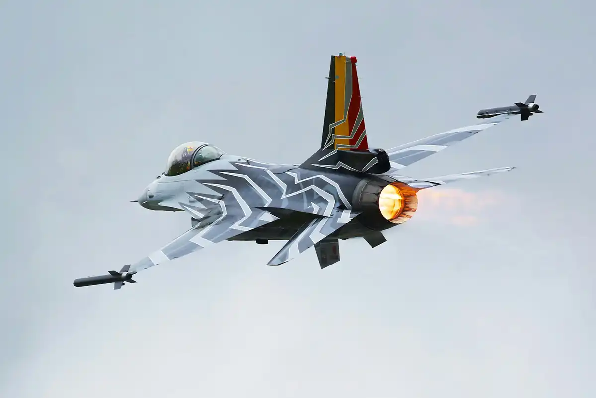a fighter jet flying through a cloudy sky